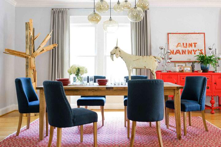 In this photo provided by Brian Patrick Flynn/HGTV.com, a dining room designed by Flynn gives folk art a more sophisticated spin by pairing rustic elements with clean tailored accents such as the custom drapery and a soft dove grey wall color. Flynn is often tasked with putting a softer spin on rustic farmhouse style for his female clients who long for a fresh spin on shabby chic.