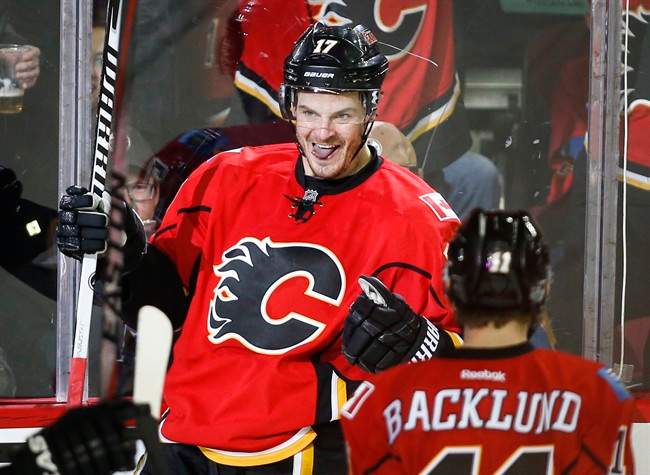 Calgary Flames' Lance Bouma celebrates his game-winning goal with teammates during third period NHL hockey action against the Edmonton Oilers in Calgary, Saturday, Jan. 31, 2015.