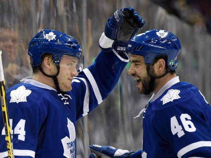 Toronto Maple Leafs' Morgan Rielly, left, celebrates his goal against the Edmonton Oilers with teammate Roman Polak during second period NHL action in Toronto on Saturday, Feb. 7, 2015.
