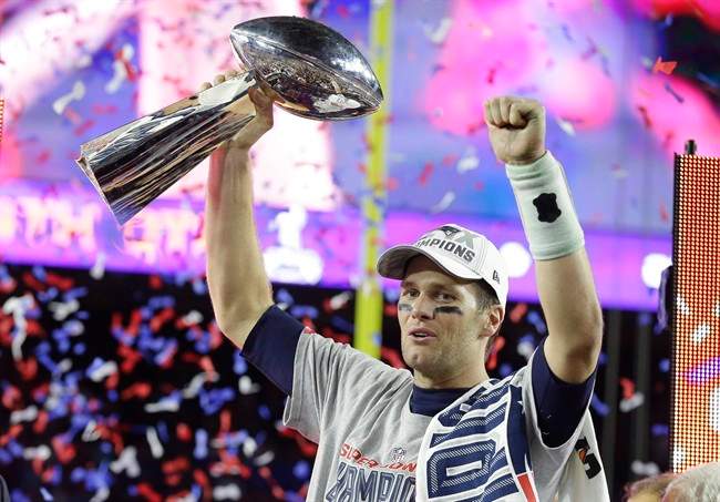 New England Patriots quarterback Tom Brady celebrates with the Vince Lombardi Trophy after the NFL Super Bowl XLIX football game against the Seattle Seahawks Sunday, Feb. 1, 2015, in Glendale, Ariz. The Patriots won 28-24. 