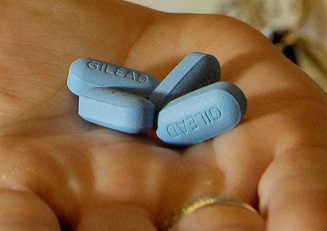 In this file photo, a doctor holds Truvada pills at her office in San Francisco.
