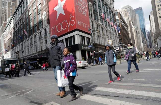 In this Feb. 19, 2015 photo, Macy's shoppers leave the retailer's flagship store, Thursday, Feb. 19, 2015 in New York.