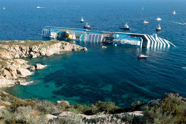 FILE - In this Jan. 14, 2012 file photo the luxury cruise ship Costa Concordia leans on its side after running aground in the tiny Tuscan island of Giglio, Italy. 