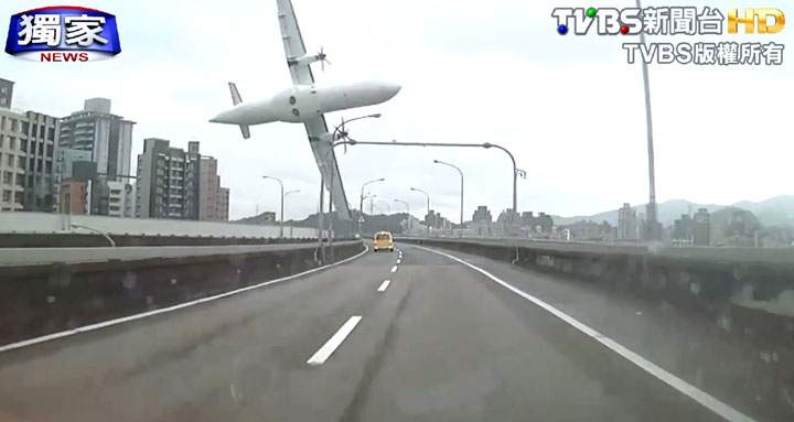 This image taken from video provided by TVBS shows a commercial airplane moments before it clipped an elevated roadway and careened into a river in Taipei, Taiwan, Wednesday, Feb. 4, 2015.