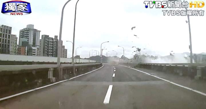 This image taken from video provided by TVBS shows an elevated roadway just after a commercial airplane clipped it and careened into a river in Taipei, Taiwan, Wednesday, Feb. 4, 2015.