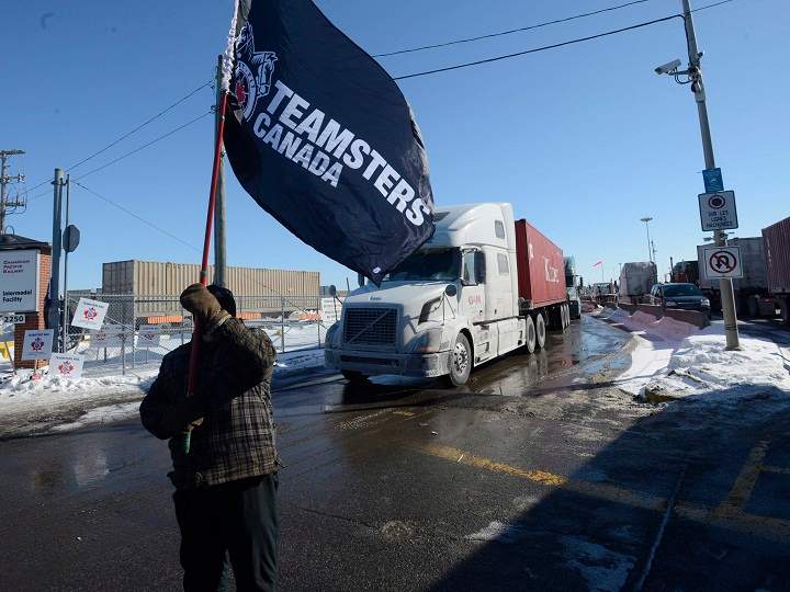 A Canadian Pacific Railway worker walks the picket line while on strike at the Cote Saint-Luc railyard in Montreal on Monday, Feb. 16, 2015.
