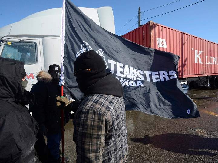 Canadian Pacific Railway workers walk the picket line while on strike at the Cote Saint-Luc railyard in Montreal on Monday, Feb. 16, 2015.