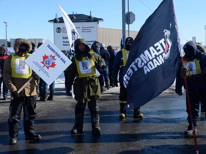 Canadian Pacific Railway workers walk the picket line while on strike at the Cote Saint-Luc railyard in Montreal on Monday, Feb. 16, 2015.