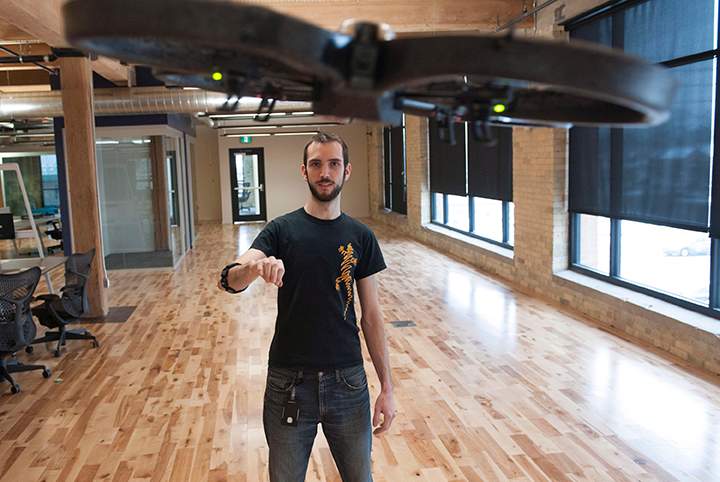 Mark DiFranco, a software engineer, uses a Myo gesture control armband to fly a drone at the Thalmic Labs headquarters in Kitchener on Thursday, December 11, 2014.