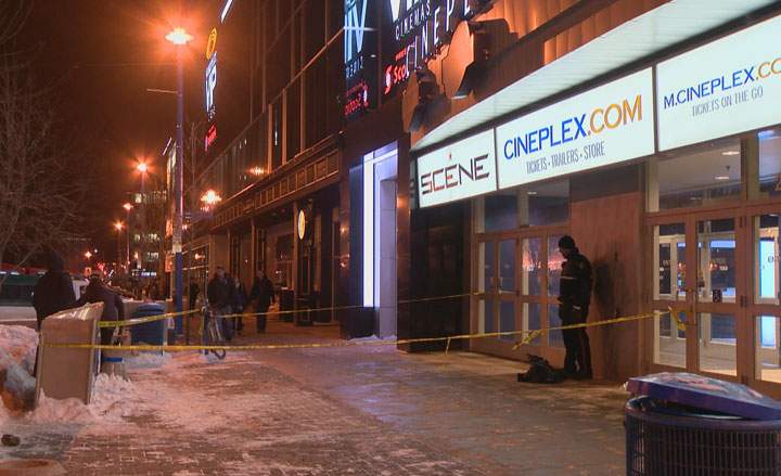 Officers tape off an area outside the Scotiabank Theatre Saskatoon and VIP after a reported stabbing Friday evening.