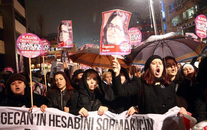 Women shout slogans and hold a portrait of 20-year-old Ozgecan Aslan during a demonstration against Aslan’s murder in Ankara on February 16, 2015.