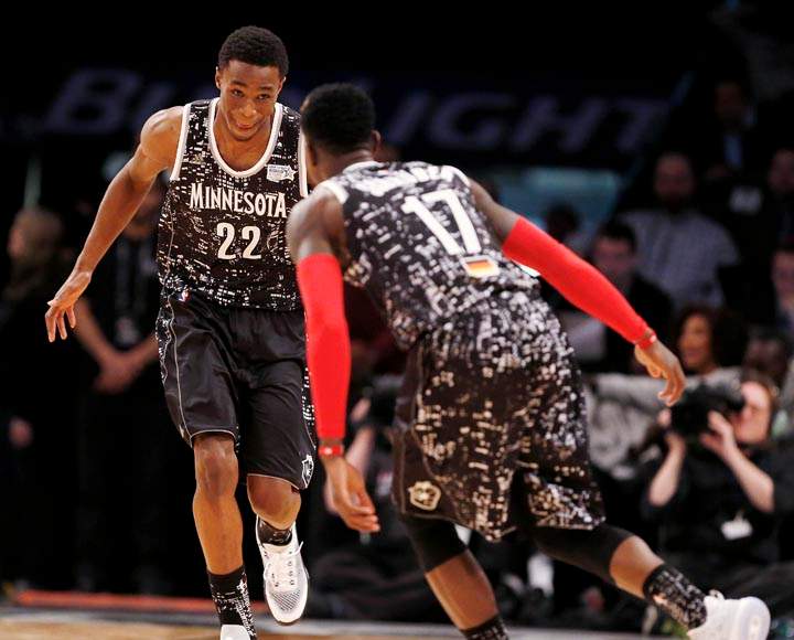 World Team's Andrew Wiggins, left, of the Minnesota Timberwolves, and Dennis Schroder, of the Atlanta Hawks, celebrate after Schroder assisted Wiggins on a basket during the first half of the Rising Stars NBA All-Star Challenge against the U.S. Team, Friday, Feb. 13, 2015, in New York.