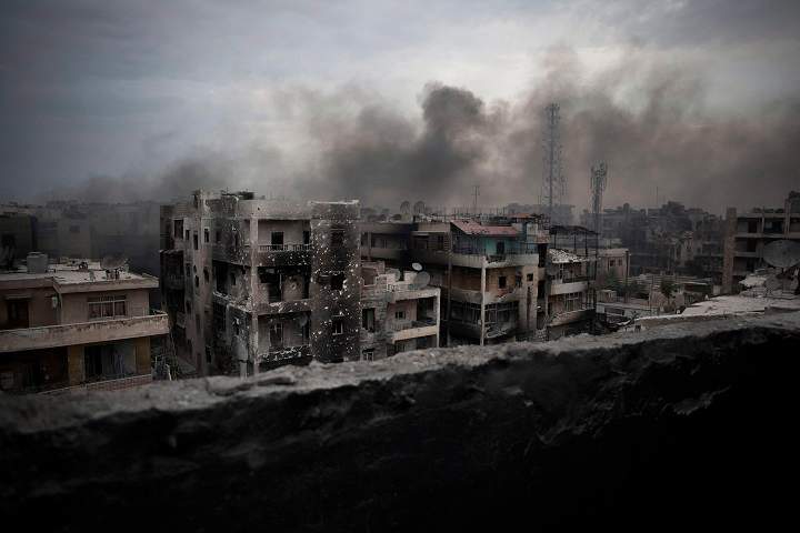 In this Tuesday, Oct. 2, 2012 file photo, smoke rises over Saif Al Dawla district, in Aleppo, Syria. 