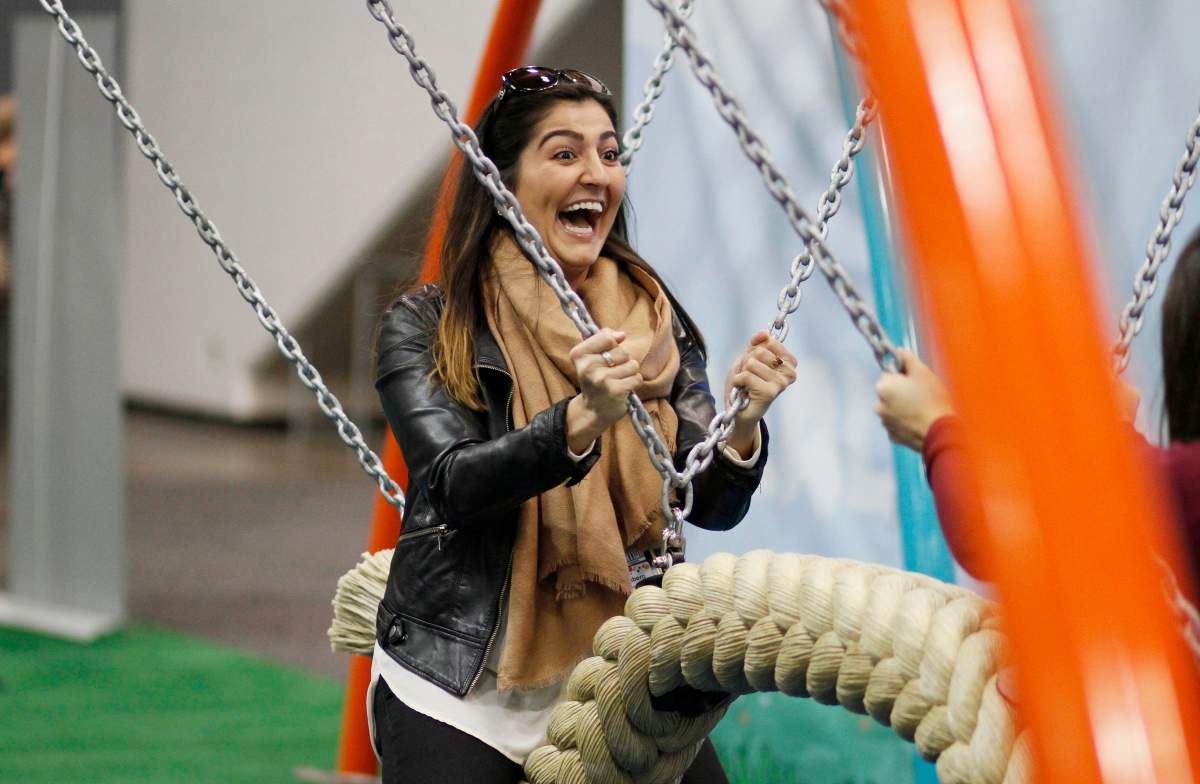 Sarah Hashemyan rides a swing in the Biba smart playground at the Game Developers Conference, Wednesday, March 4, 2015, in San Francisco.