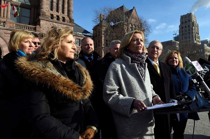 Whitby-Oshawa MPP Christine Elliott, centre, speaks at a news conference at Queen's Park in Toronto on Thursday, March 5, 2015.