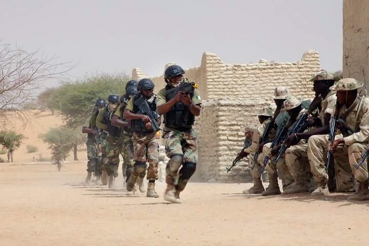 Nigerian special forces run past Chadian troops in an hostage rescue exercise at the end of the Flintlock exercise in Mao, Chad, Saturday, March 7, 2015.