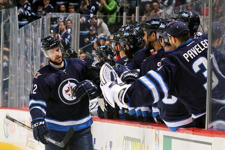 Drew Stafford (12) of the Winnipeg Jets celebrates his first-period goal against the Los Angeles Kings with teammates at the bench on Sunday at the MTS Centre in Winnipeg.
