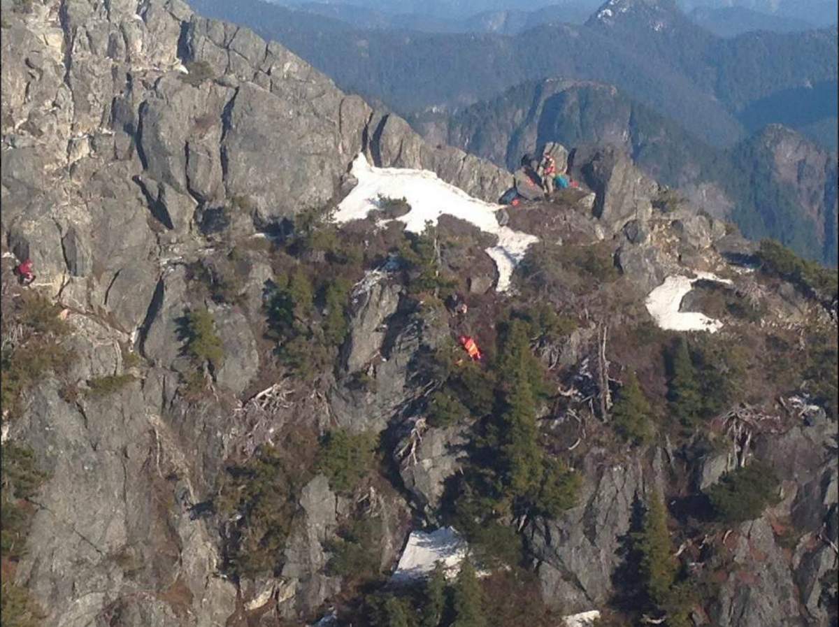 North Shore Rescue crews tend to an injured man who fell down a slope on Crown Mountain this weekend. 