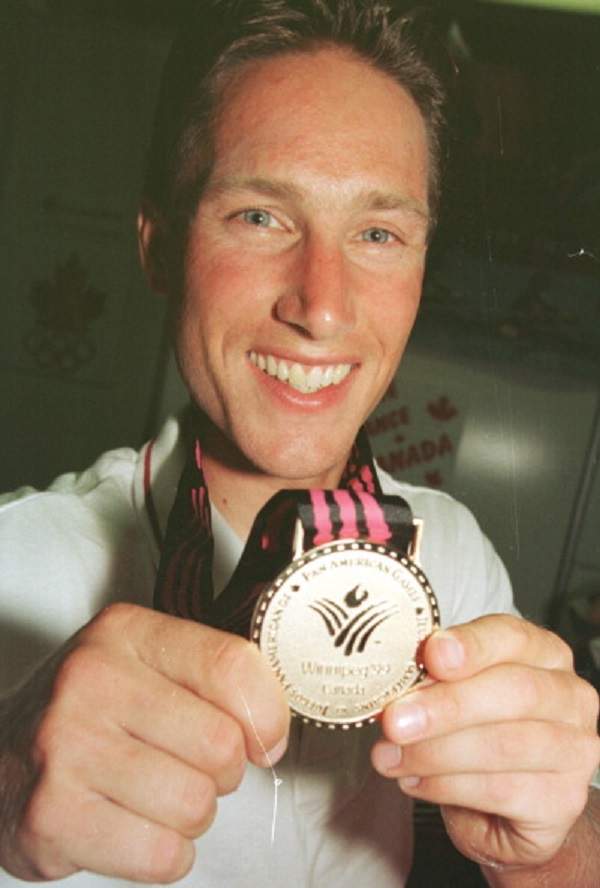 A surprise winner in mens cycling time trials,Eric Wohlberg from Levack,Ont(near Sudbury) proudly shows off his gold medal at press conference this evening.at the PanAm Games in Winnipeg July 25, 1999.