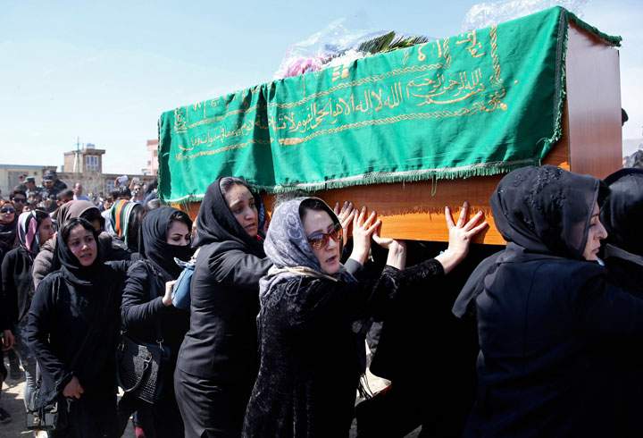 Afghan women's rights activists carry the coffin of 27-year-old Farkhunda, an Afghan woman who was beaten to death by a mob, during her funeral in Kabul, Afghanistan, Sunday, March 22, 2015. Hundreds of people gathered in northern Kabul for the funeral.