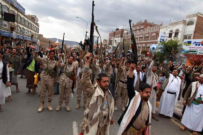 Shiite rebels, known as Houthis, hold up their weapons to protest against Saudi-led airstrikes during a rally in Sanaa, Yemen, Thursday, March 26, 2015. 