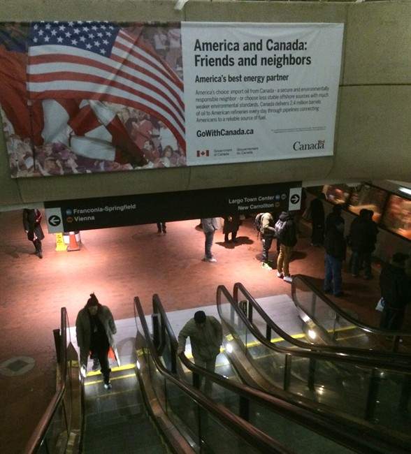 A billboard promoting a Canada – U.S. energy partnership is shown at a subway station in Washington, D.C., on January 28, 2014.