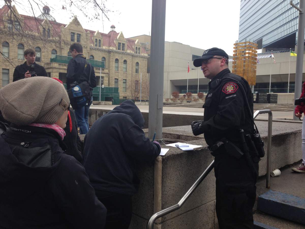 Witnesses at anti-racism rally being interviewed by police Saturday afternoon.
