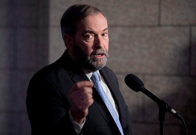 NDP Leader Tom Mulcair speaks with the media following caucus in Ottawa on March 25, 2015. Tom Mulcair says an NDP government would take tax benefits from those who need them least and give them to those who need them most. 