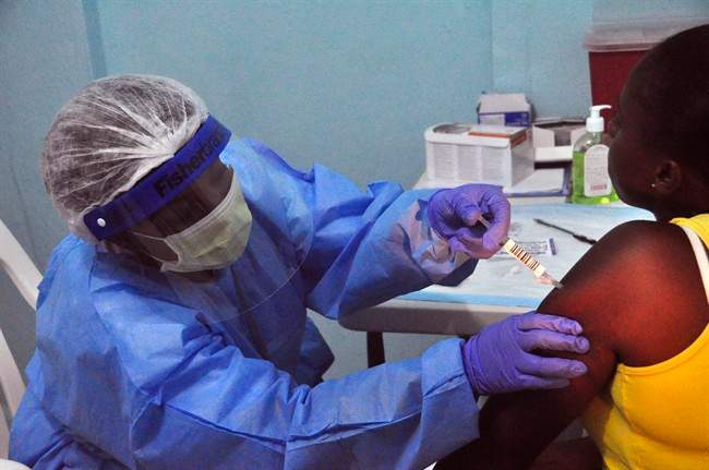 A woman is injected by a health care worker as she takes part in a Ebola virus vaccine trial at the Redemption hospital in Monrovia, Liberia, Feb.2, 2015.