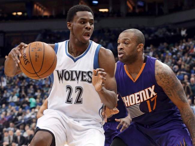 Minnesota Timberwolves' Andrew Wiggins, left, drives around Phoenix Suns' P.J. Tucker during the second half of an NBA basketball game, Friday, Feb. 20, 2015, in Minneapolis.