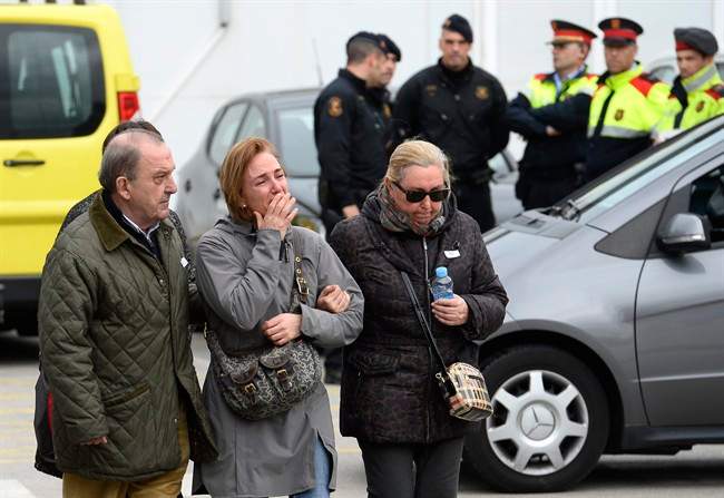 Crying people arrive at Barcelona airport in Spain.