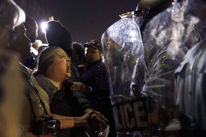 A protester yells at police outside the Ferguson Police Department, Wednesday, March 11, 2015, in Ferguson, Mo.