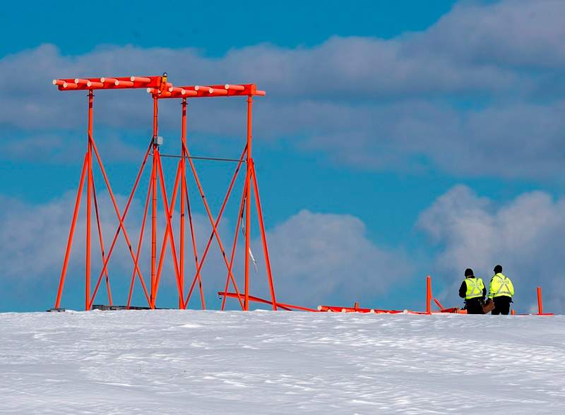 Investigators look at a structure believed to have been hit by Air Canada flight 1AC624 that crashed early Sunday morning during a snowstorm, at Stanfield International Airport in Halifax on Sunday, March 29, 2015. Air Canada says 25 people were taken to hospital.