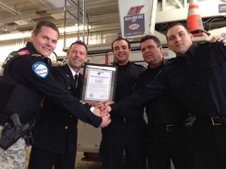 Montreal firefighters were recognized for stopping two armed robbers from holding up a Westmount pharmacy in November 2014.
