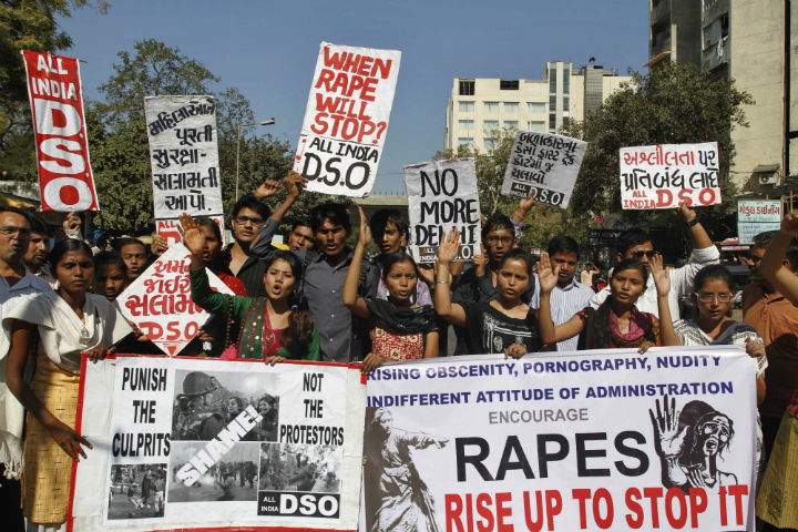 Members of All India Democratic Students Organization (DSO) hold placards and shout slogans condemning the brutal gang-rape of a woman on a moving bus in New Delhi during a protest in Ahmadabad, India, Monday, Dec. 24, 2012.