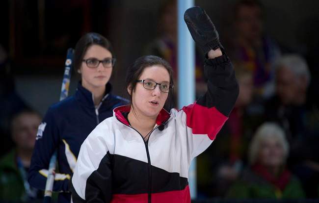 Nova Scotia fourth Mary Fay, left, looks over the shoulder of Ontario fourth Megan Smith as she calls a shot during the gold medal draw at the Canada Winter Games in Prince George, B.C. Saturday, Feb. 28, 2015. 