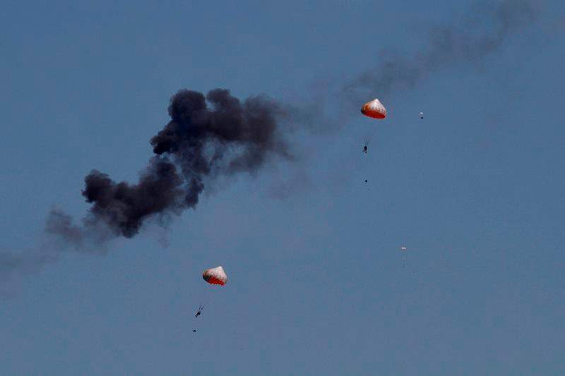 Pilots from Indonesia’s Jupiter aerobatics team are ejected after a mid-air collision during a practice session at the Langkawi International Maritime and Aerospace (LIMA) exhibition in Langkawi, Malaysia, on Sunday, March 15, 2015.