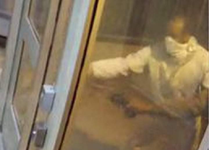 Security camera image of Suspect #2 and arm of Suspect #1.