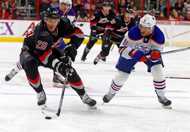 Carolina Hurricanes' Alexander Semin (28), of Russia, works the puck on Edmonton Oilers' Derek Roy (8) during the second period of an NHL hockey game in Raleigh, N.C., Sunday, March 8, 2015, in Raleigh, N.C.