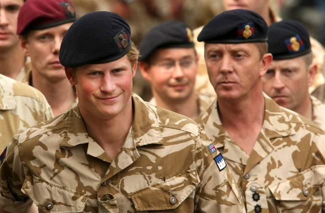 File-This May 5, 2008, file photo shows Britain's Prince Harry, left, arriving for a thanksgiving service at the Army Garrison Church in Windsor, England, after receiving a campaign medal for serving in Afghanistan. 