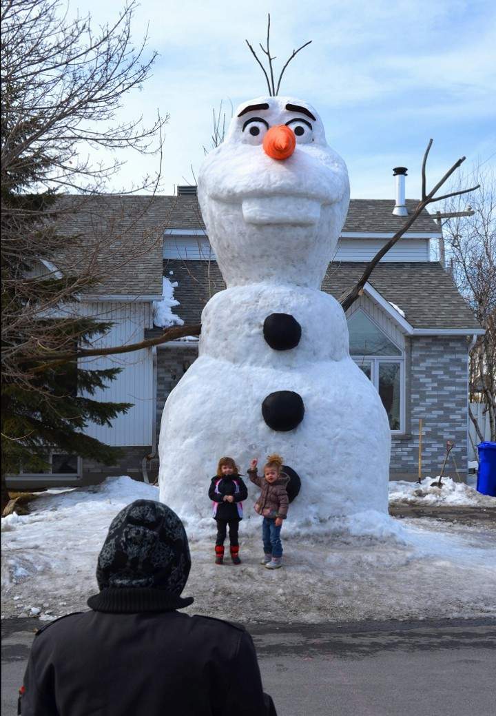 Montrealers get their photos taken in front of a 20-foot snow sculpture of Olaf in Saint-Jean-Sur-Richelieu, Que. on March 23, 2015.