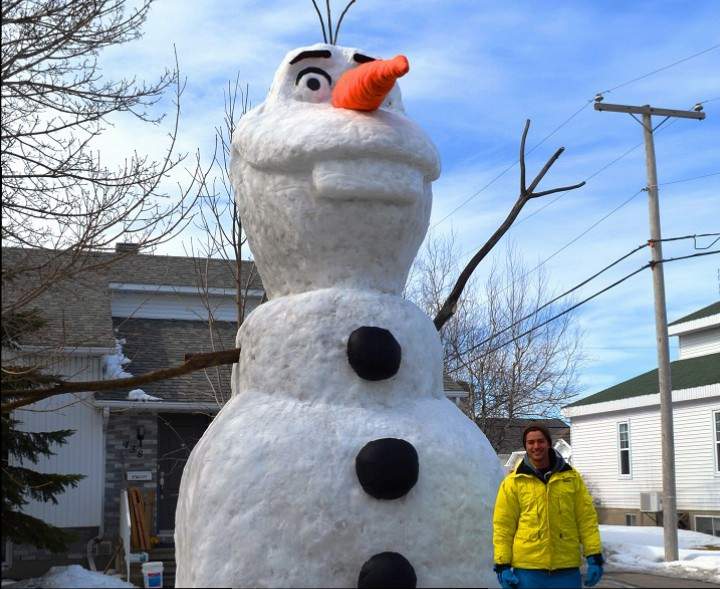 Benoît Sabourin stands in front of his 20-foot snow sculpture of Olaf in Saint-Jean-Sur-Richelieu, Que. on March 23, 2015.