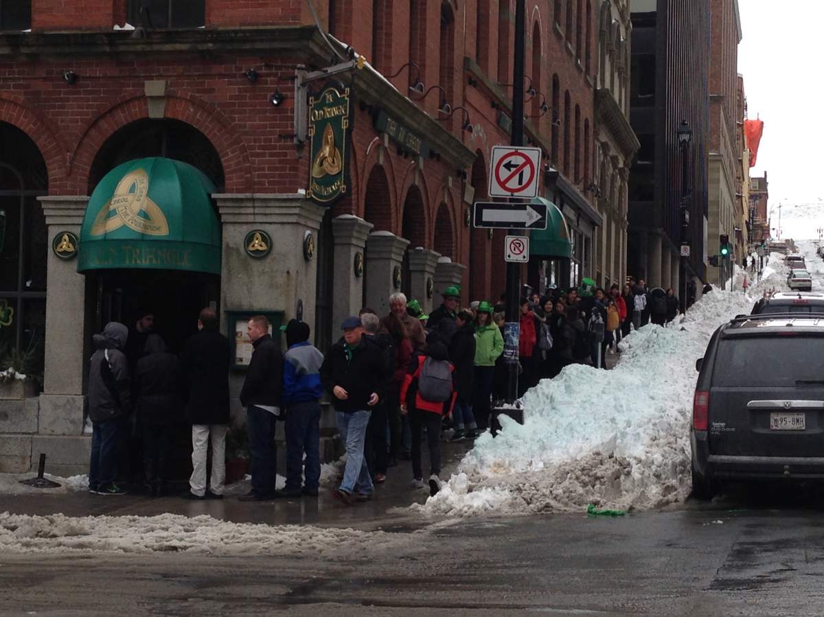 People are eager to go into the Old Triangle pub on St. Patrick's Day 2015.