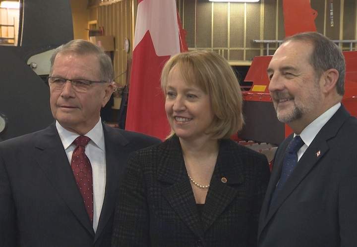 Denis Lebel with the Longueuil mayor in St-Hubert to announce federal funding for the airport on March 2, 2015.