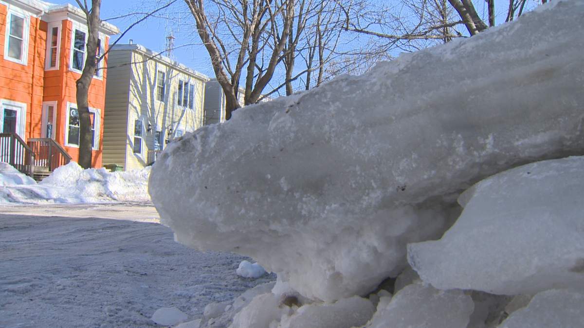 Ice slabs sit on the side of the road after crews cleared ice pack on Charles St. overnight Saturday.