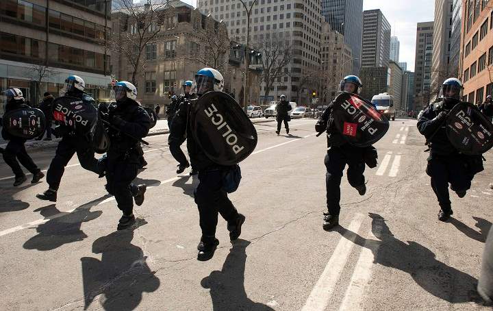 Riot police move in to break up a student demonstration against proposed austerity changes by the provincial government, Monday, March 23, 2015 in Montreal.