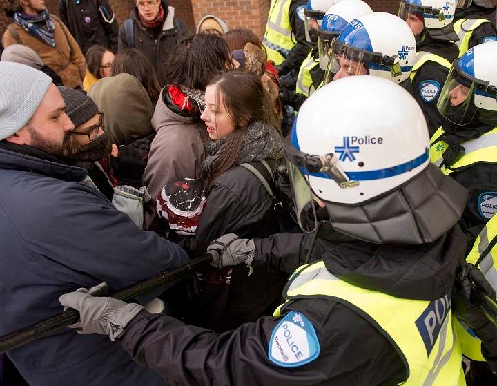 Police disperse demonstrators as students protest against proposed austerity changes by the provincial government, Monday, March 23, 2015 in Montreal.