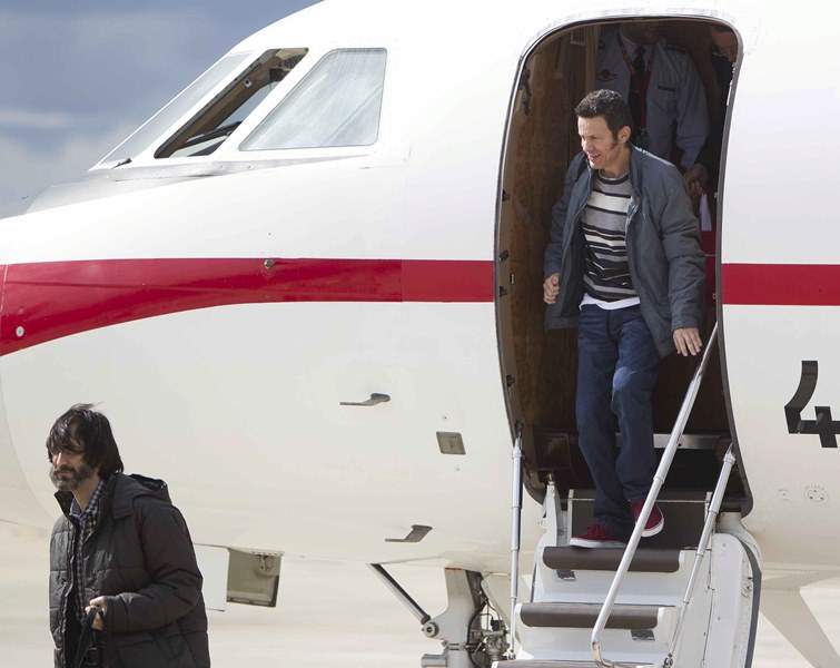 Spanish journalist Javier Espinosa (R) and freelance photographer Ricardo Garcia Vilanova alight from an aircraft at the military airbase in Torrejon de Ardoz near Madrid, on March 30, 2014 following their release from captivity in Syria.