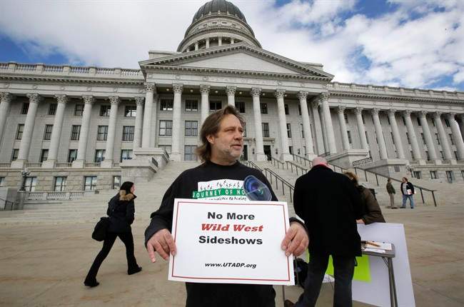 FILE - In this Jan. 27, 2015, file photo, Randy Gardner of Salt Lake City, the older brother of Ronnie Lee Gardner, the last inmate to be killed by firing squad in Utah in 2010, protests with a group opposed to capital punishment plans over one lawmaker's plan to resurrect the use of firing squads, outside the Utah State Capitol, in Salt Lake City.