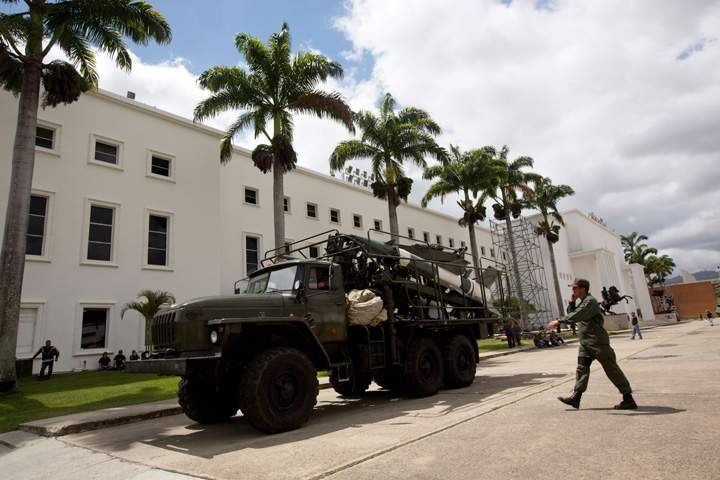 A Venezuelan soldier walks next to a missile system launcher prior to starting civilian and military exercises in Caracas, Venezuela, Saturday, March 14, 2015.